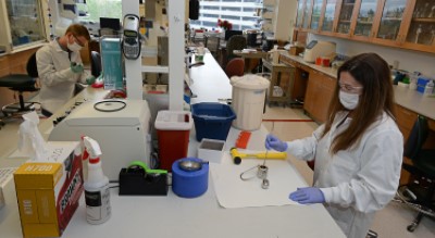 Two students working in a laboratory, distanced apart