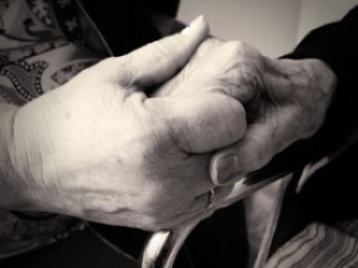 Closeup of two hands holding each other